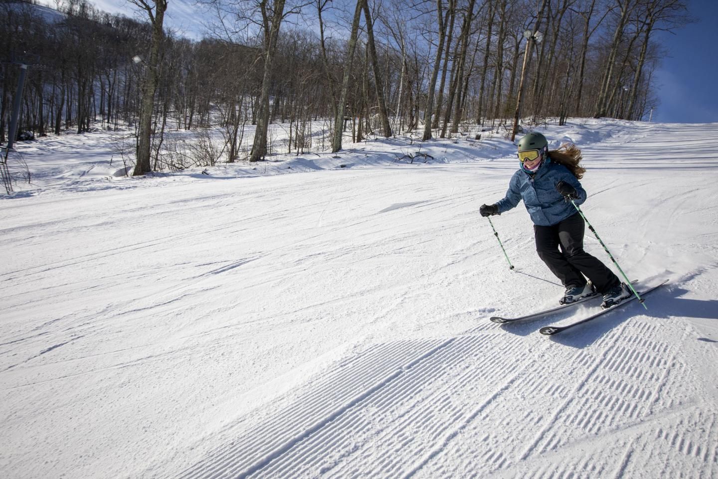 A Catamount Ski Resort Instructor carving a turn in the sunshine