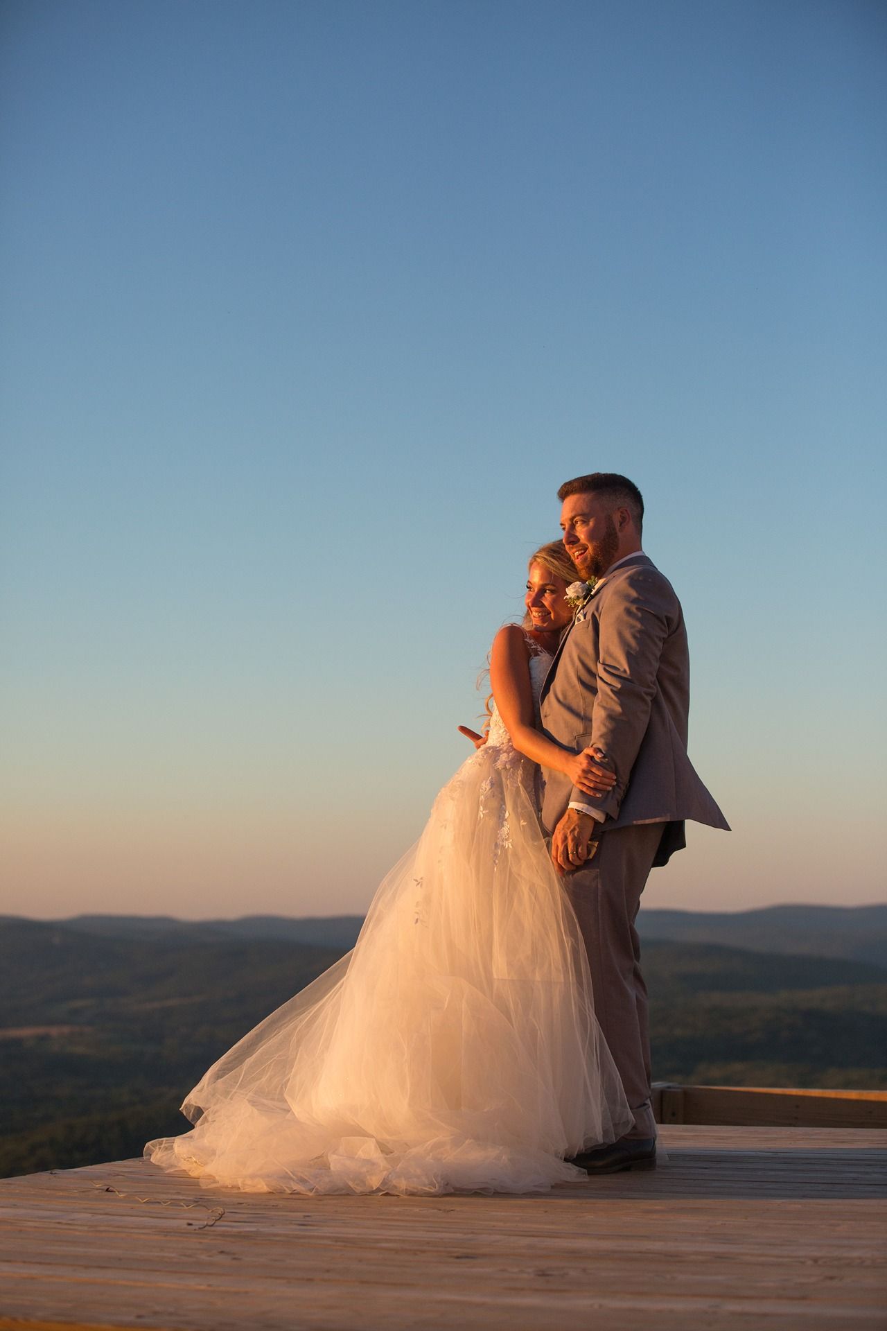 A couple looking at the sunset from the platform at the top of Catamount Resort